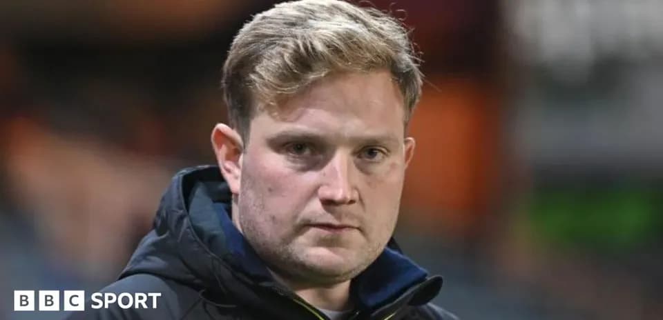 Coach looking directly at the camera during match