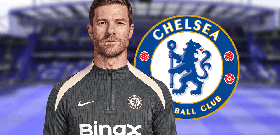 Coach in training gear with Chelsea logo background