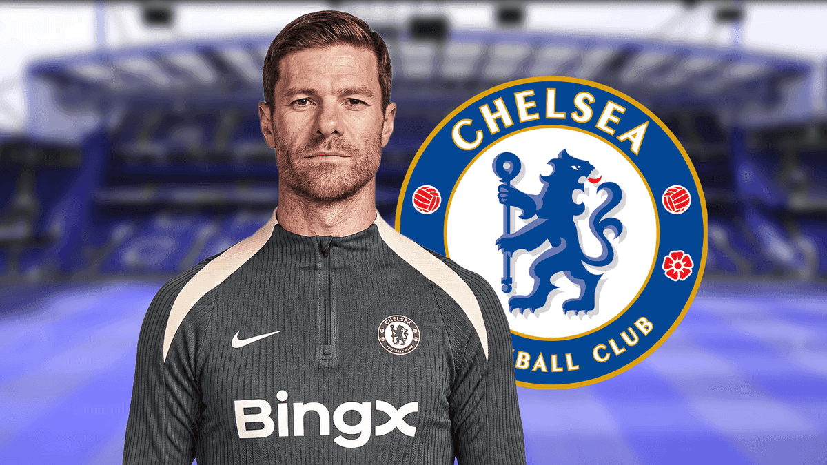 Coach in training gear with Chelsea logo background