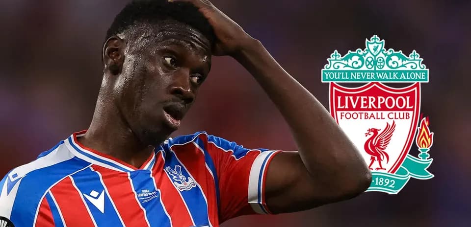 Crystal Palace player looking concerned with Liverpool logo