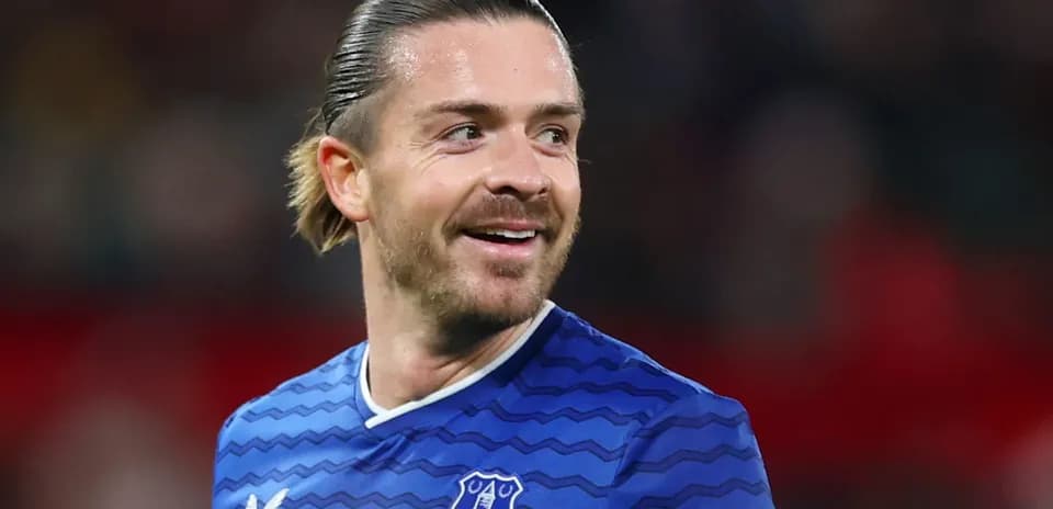 Football player in Everton jersey smiling on field