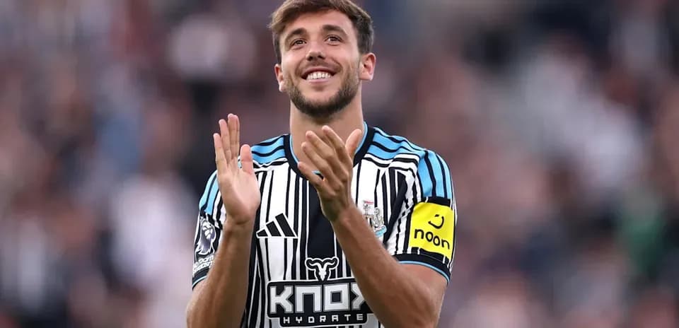Newcastle player applauding fans during match
