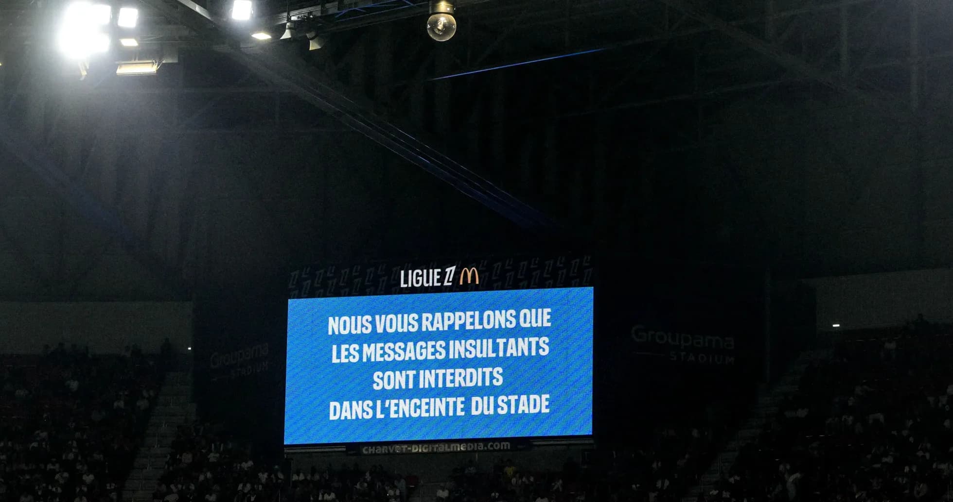 Stadium screen displaying anti-insult message during match