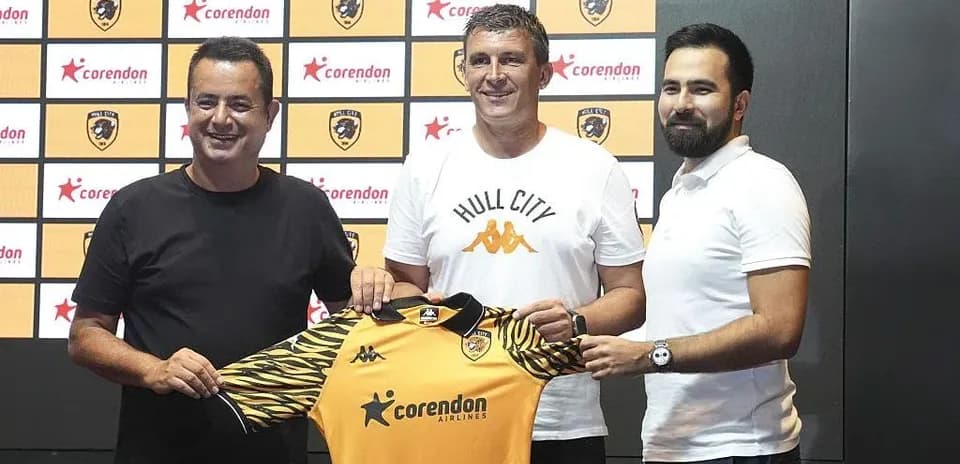 New coach holding Hull City jersey at announcement