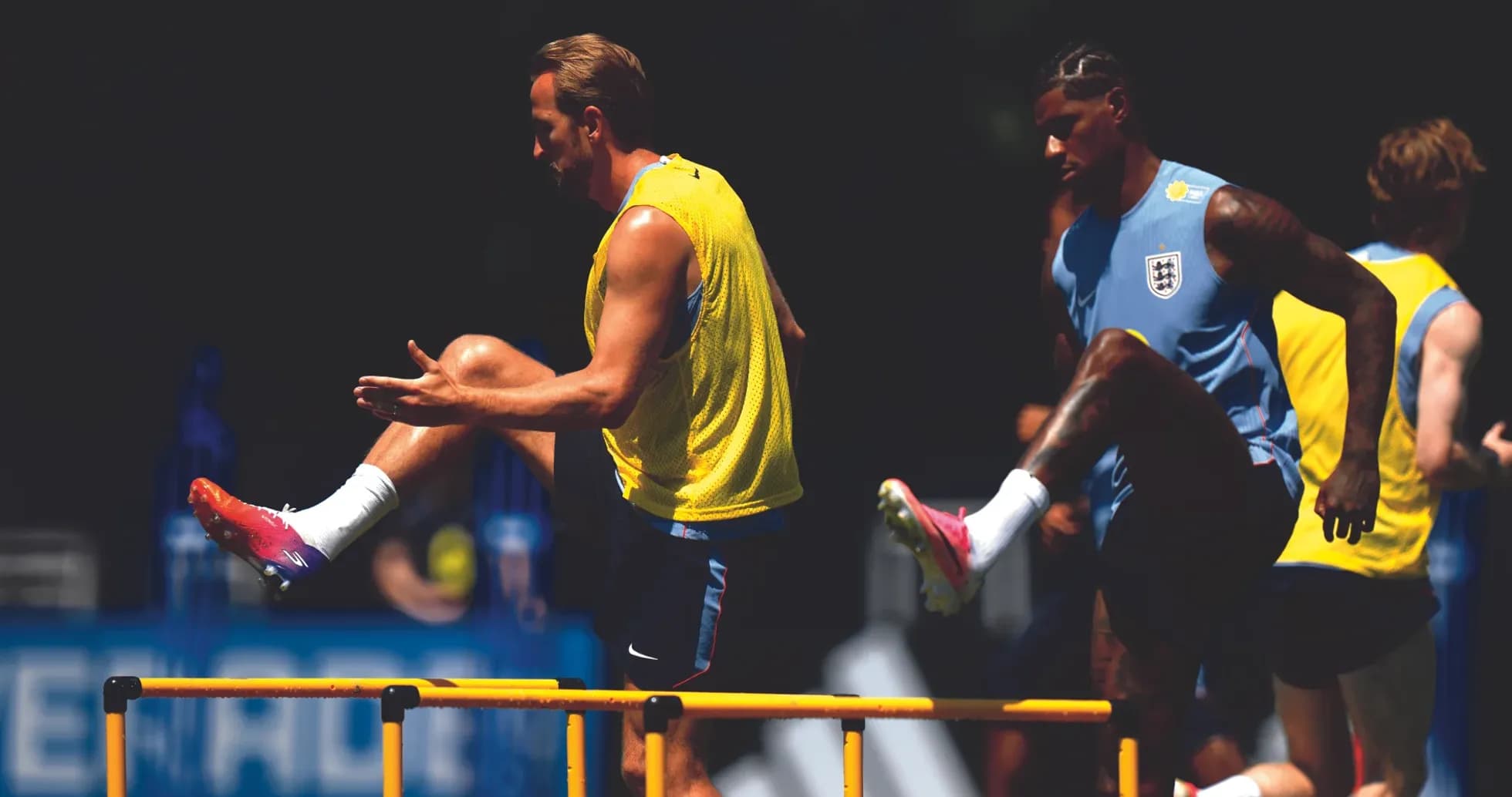 Players training by jumping over hurdles in practice