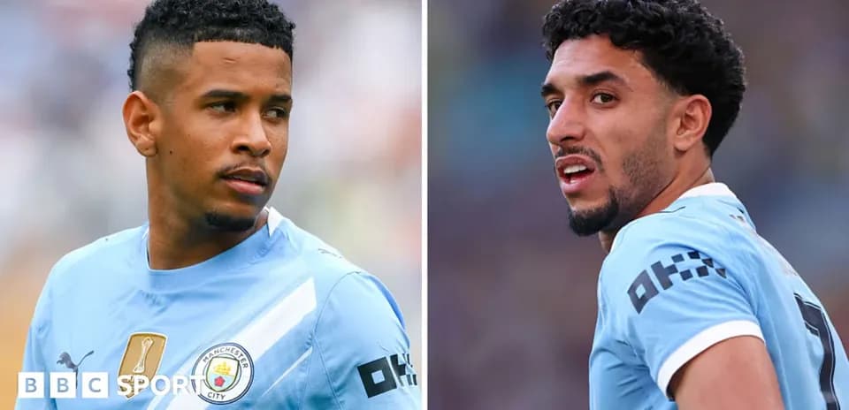 Two Manchester City players in blue kits during match