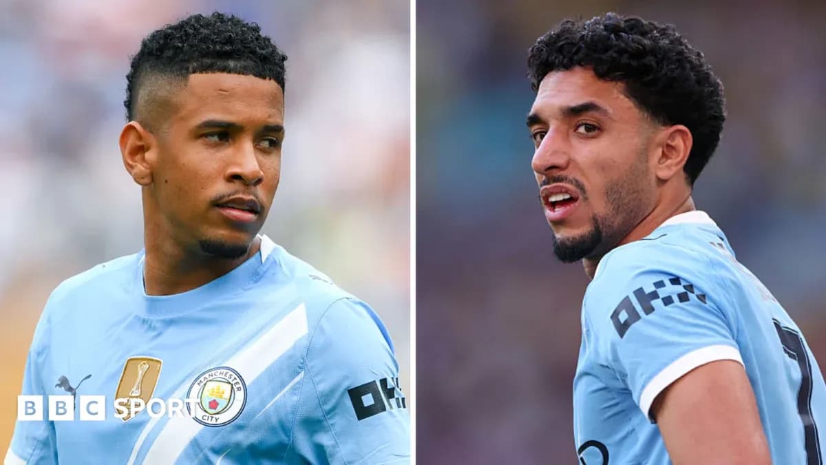 Two Manchester City players in blue kits during match