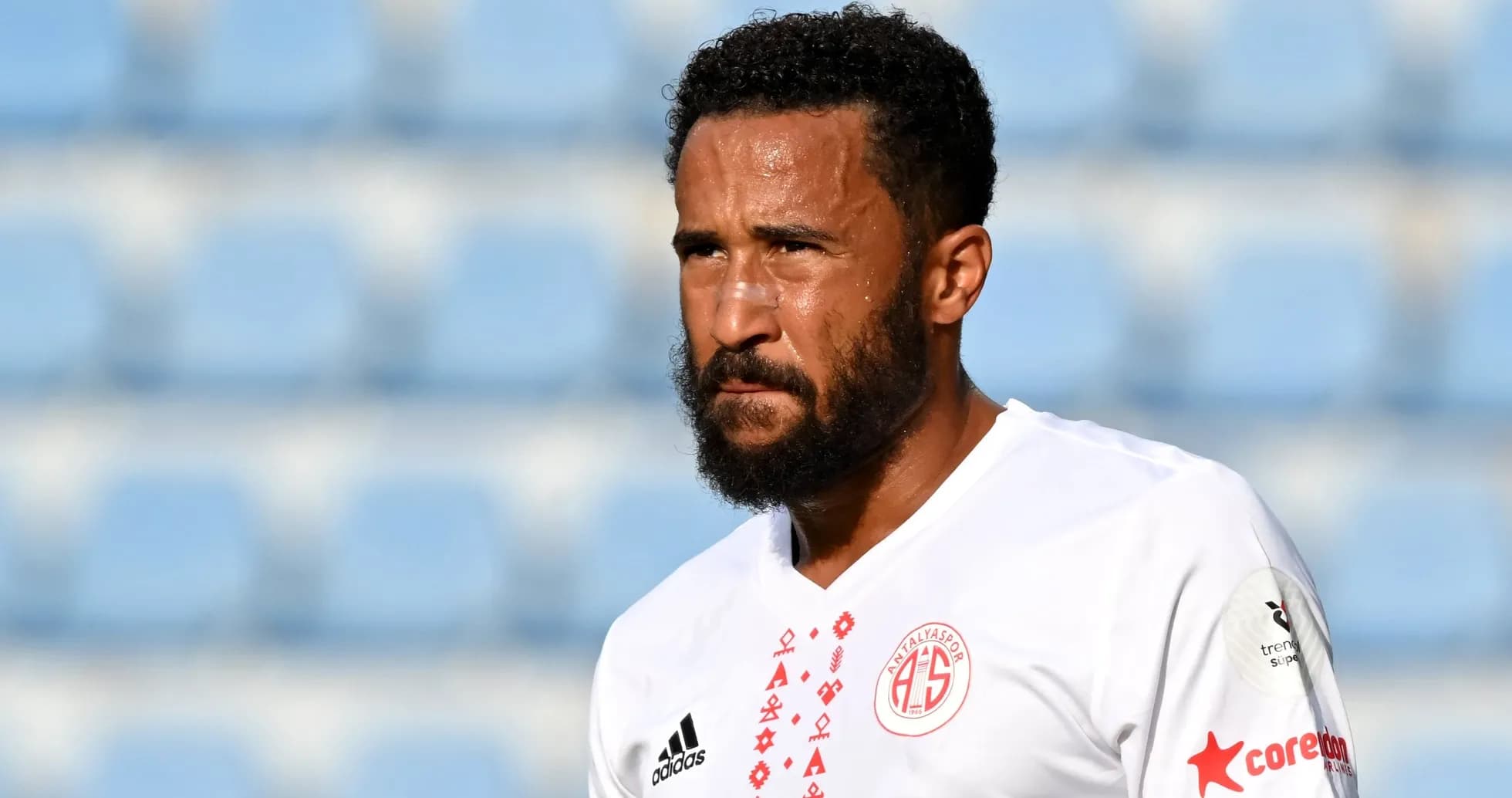 Player in white jersey during match at stadium