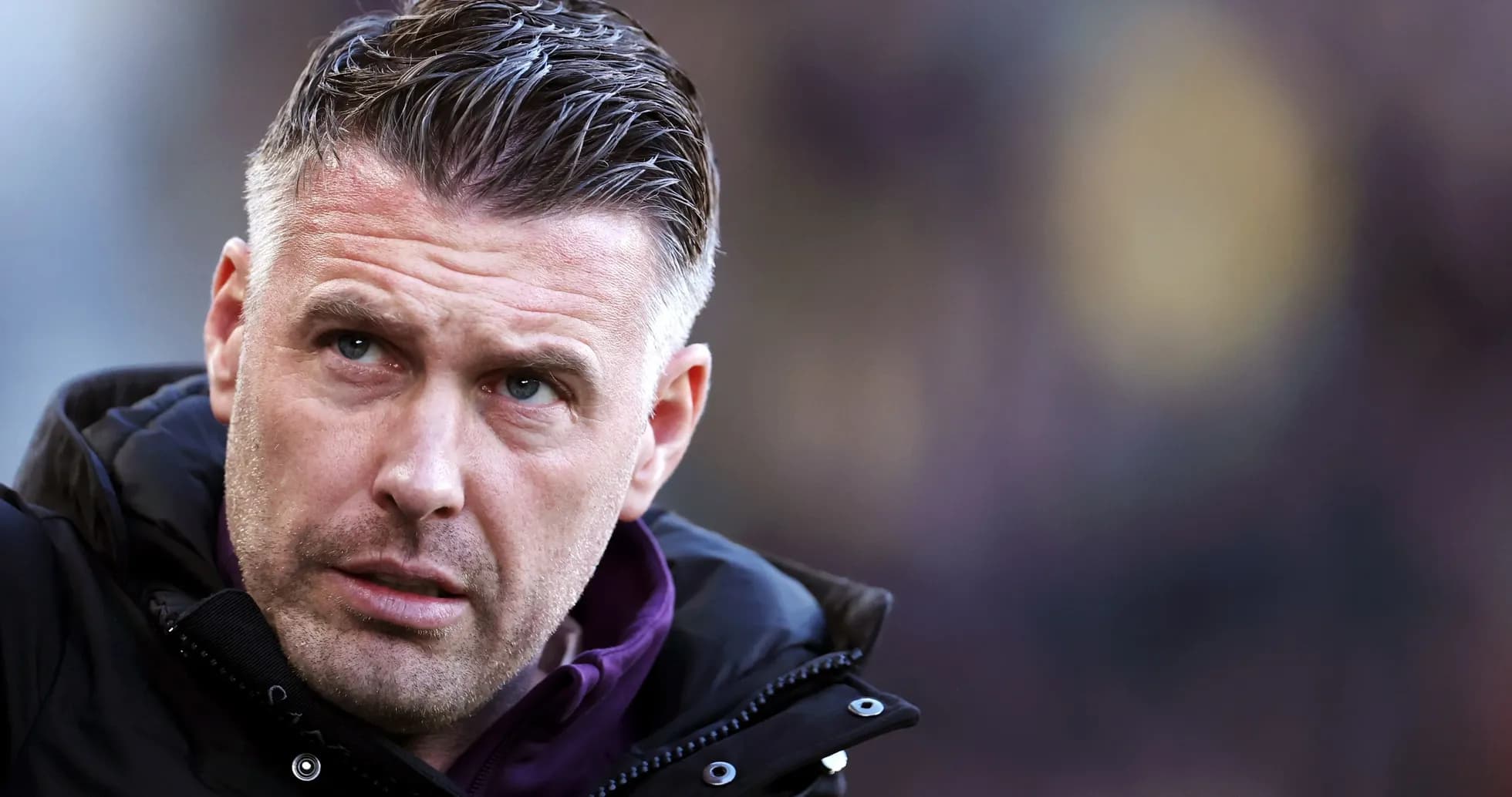 Coach focused during match on the sidelines