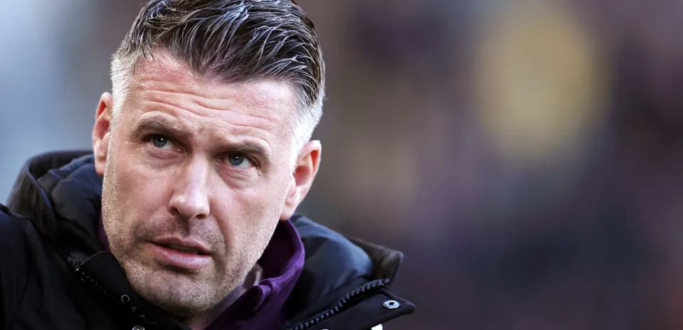 Coach focused during match on the sidelines