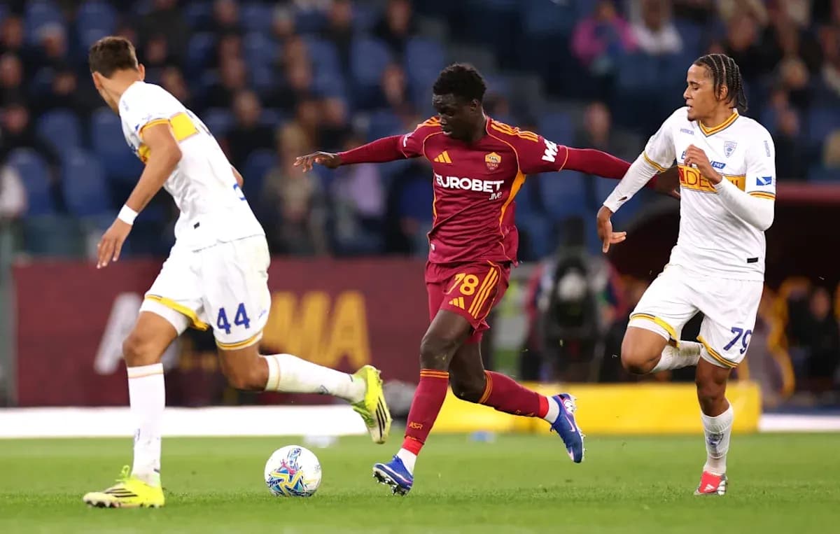 Player in red dribbling past two defenders during match