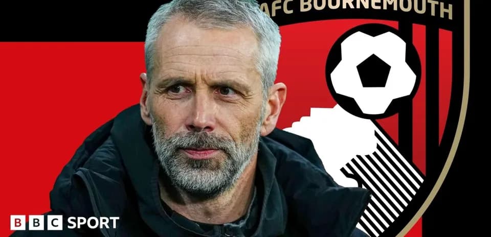 AFC Bournemouth manager with club logo in background