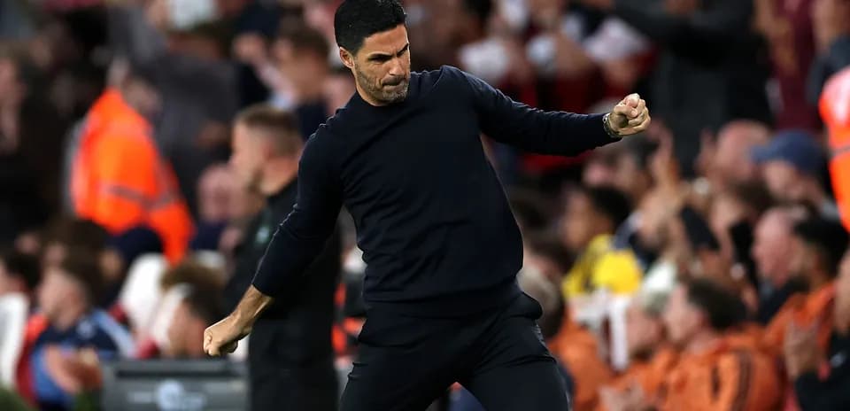 Coach celebrating during a match with fans cheering