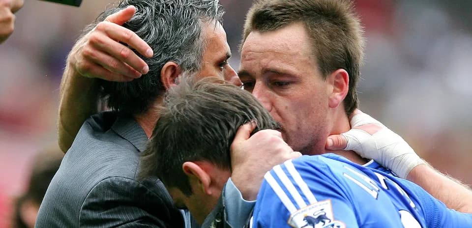 Players and coach embracing after match conclusion