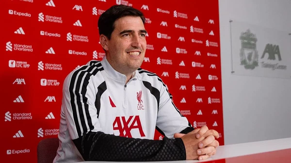 Coach speaking at Liverpool press conference table