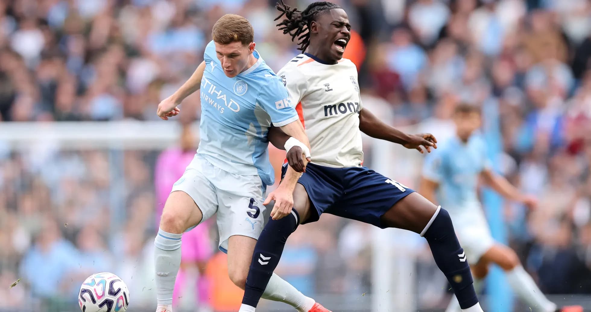 Manchester City player tackling Coventry opponent