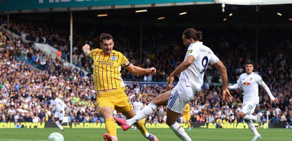 Leeds player challenging Brighton opponent during match