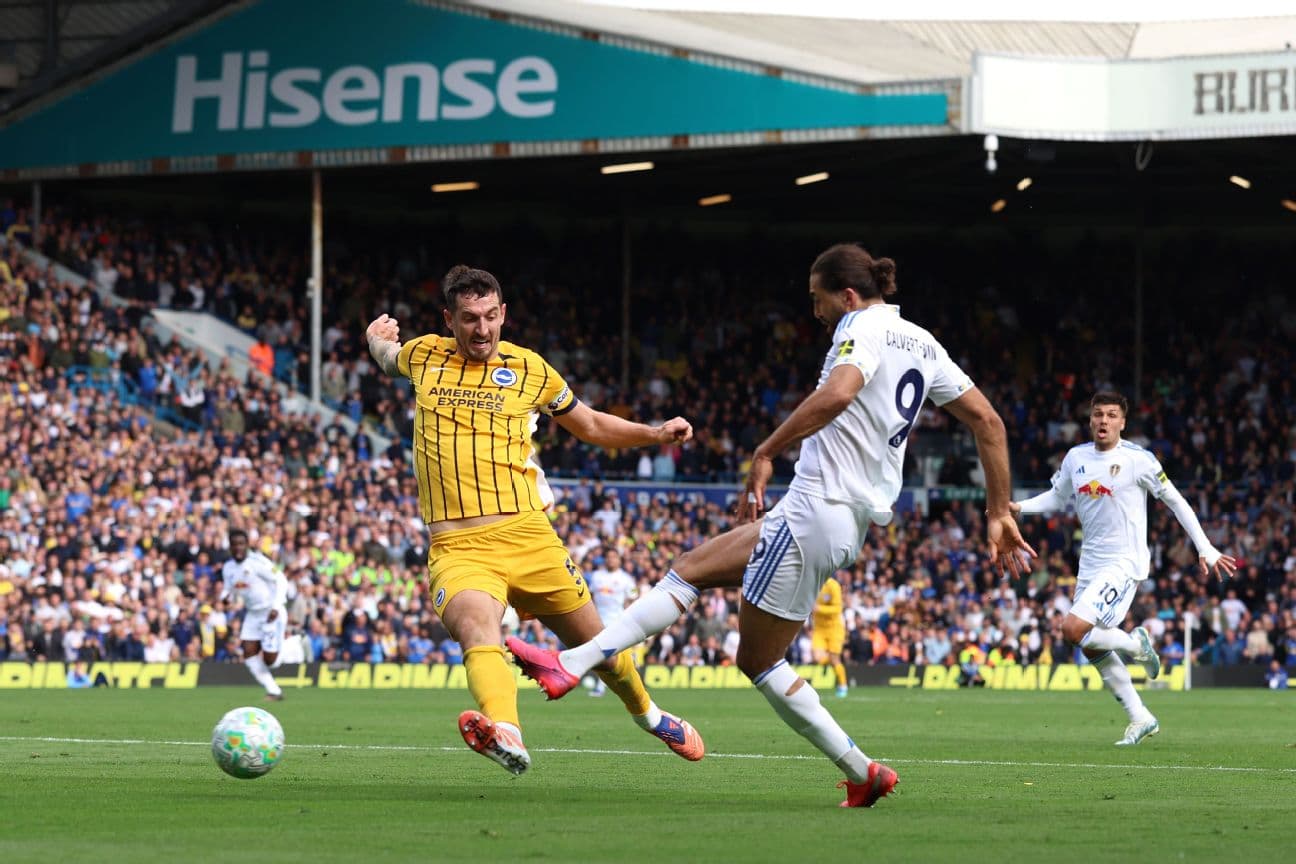Leeds player challenging Brighton opponent during match