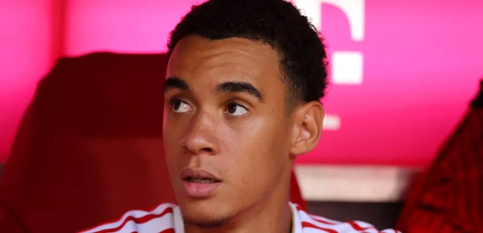 Player sitting on bench during match warm-up