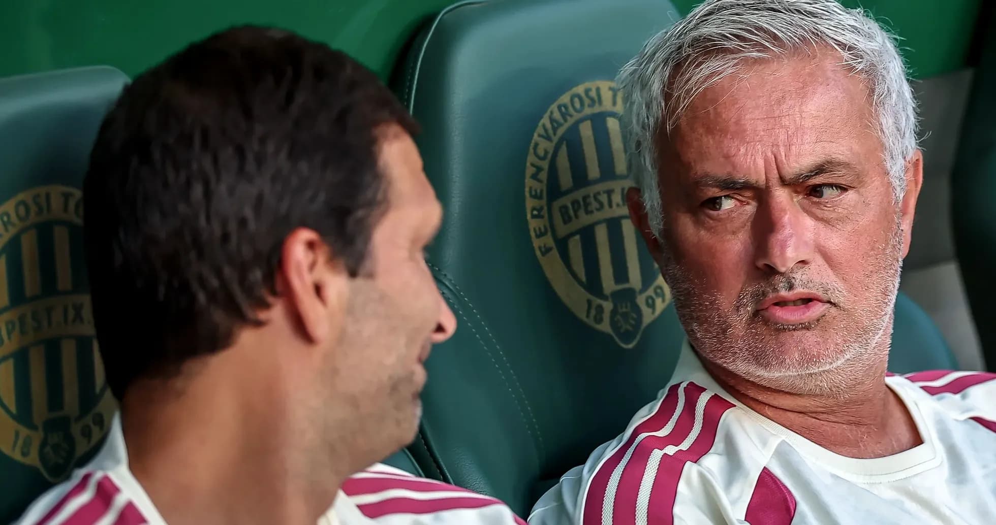 Coaches discussing on team bench during match