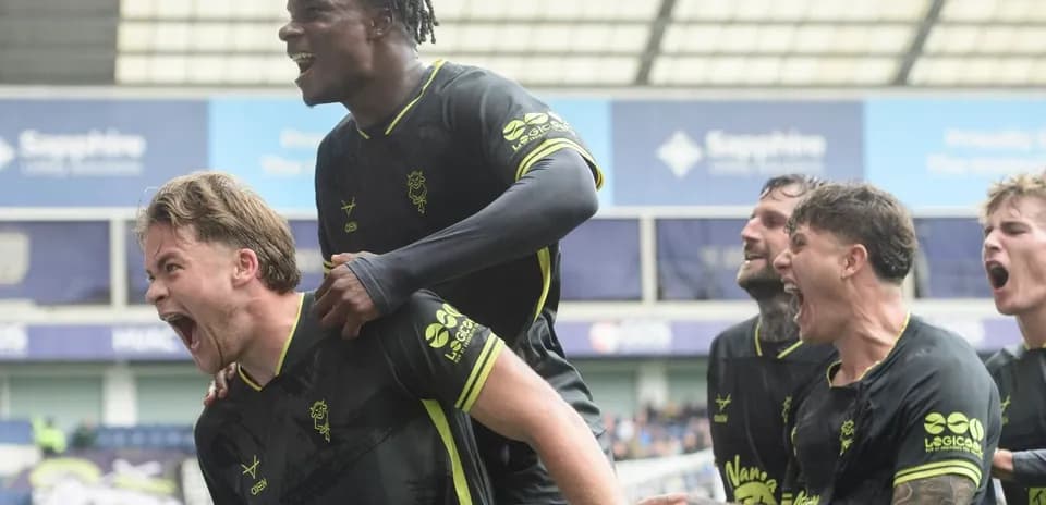 Players celebrating a goal on the pitch