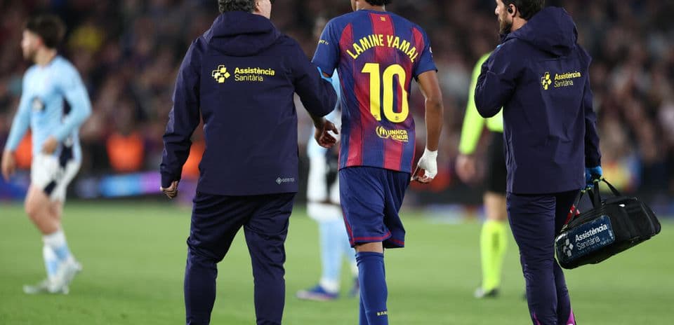 Lamine Yamal being assisted off the field by staff