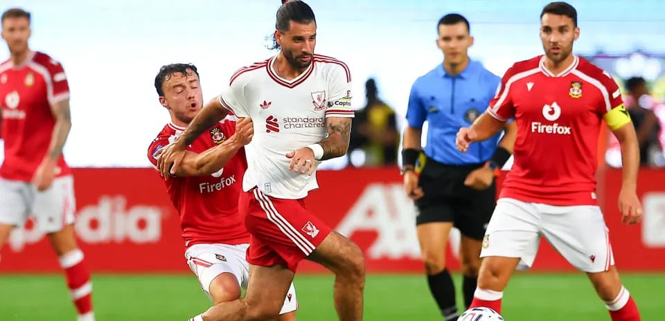 Player in white jersey evading opponent during match