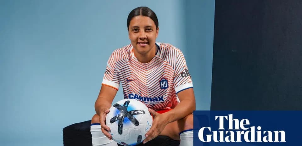 Player posing with soccer ball in studio setting