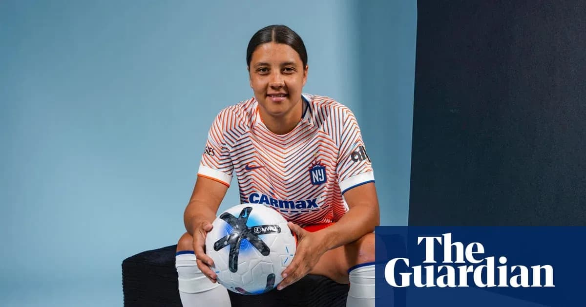 Player posing with soccer ball in studio setting