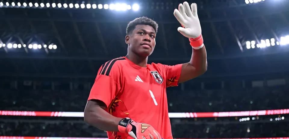 Goalkeeper waving while holding a team banner