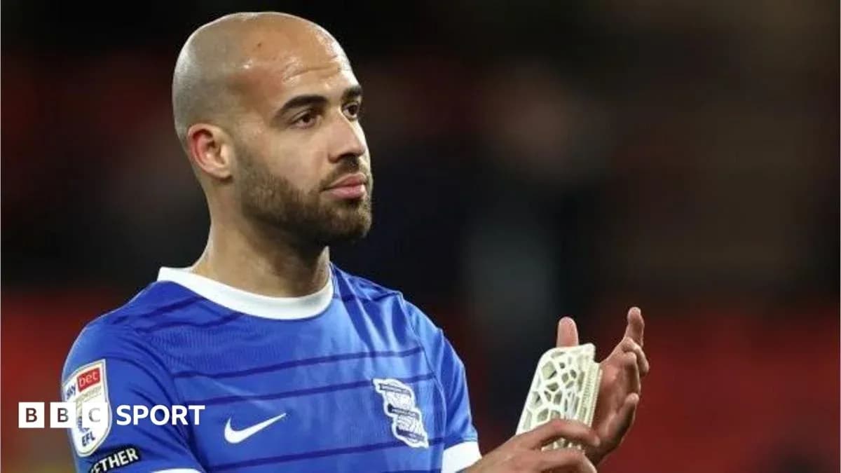 Player in blue jersey applauding after match
