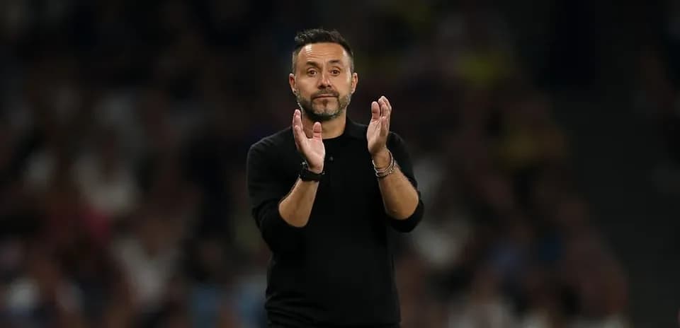 Manager applauding during a football match