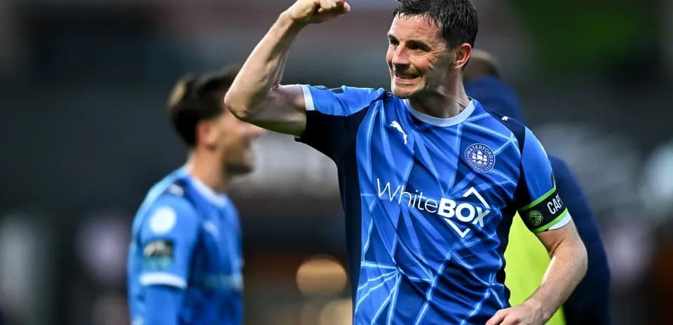 Player celebrating victory in Waterford FC jersey