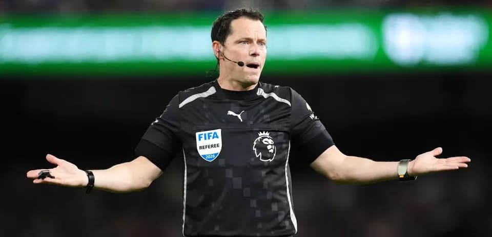 Referee gesturing during a football match