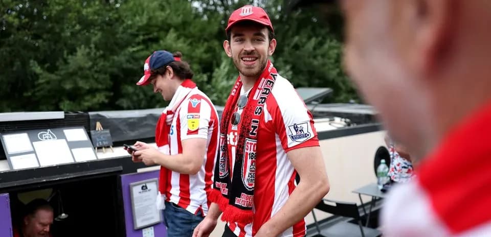 Fans wearing Stoke City shirts and scarves at event