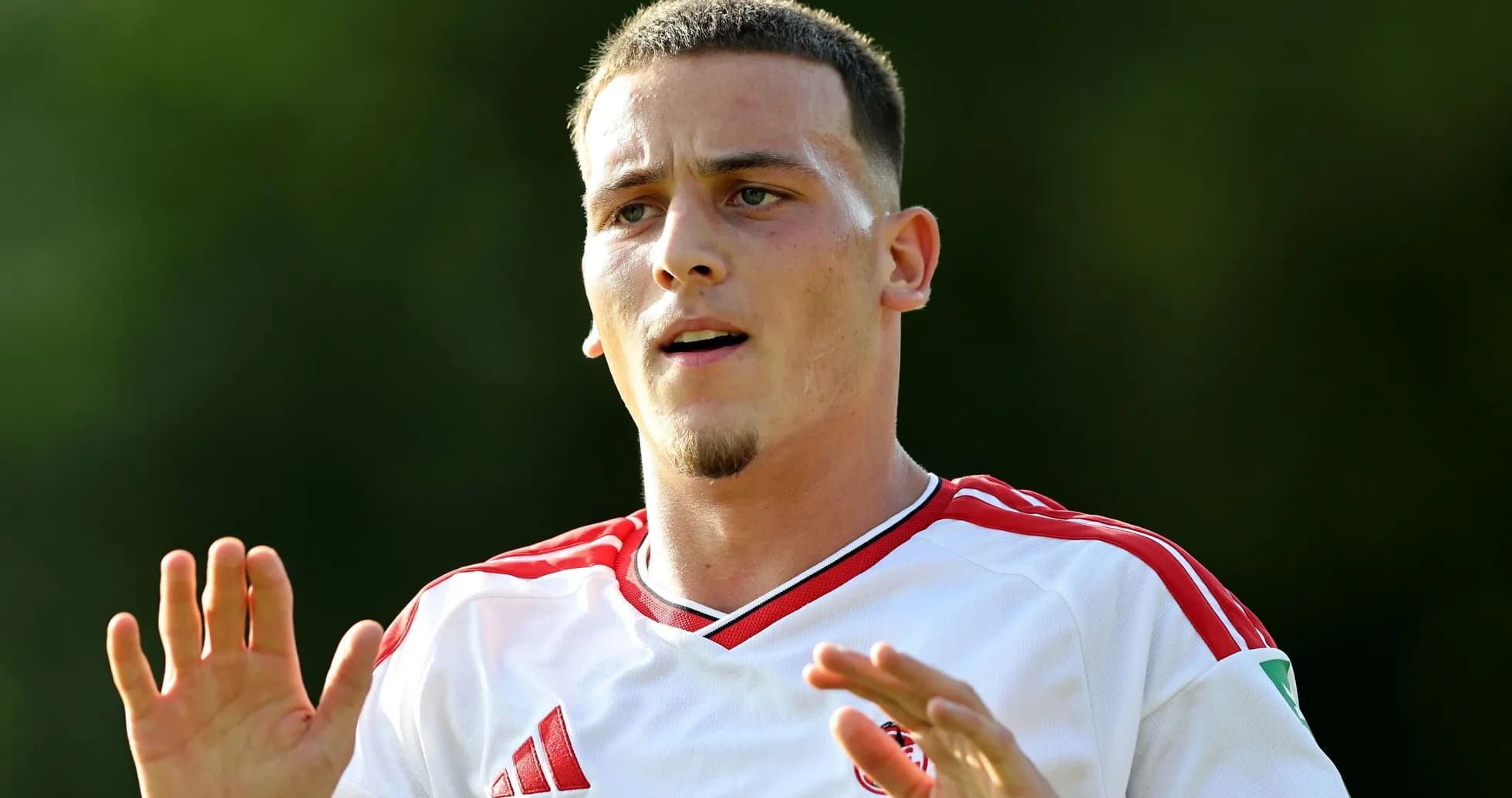 Player gesturing during training session in white kit