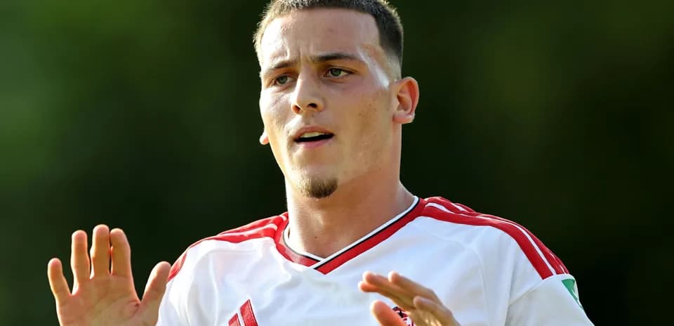 Player gesturing during training session in white kit