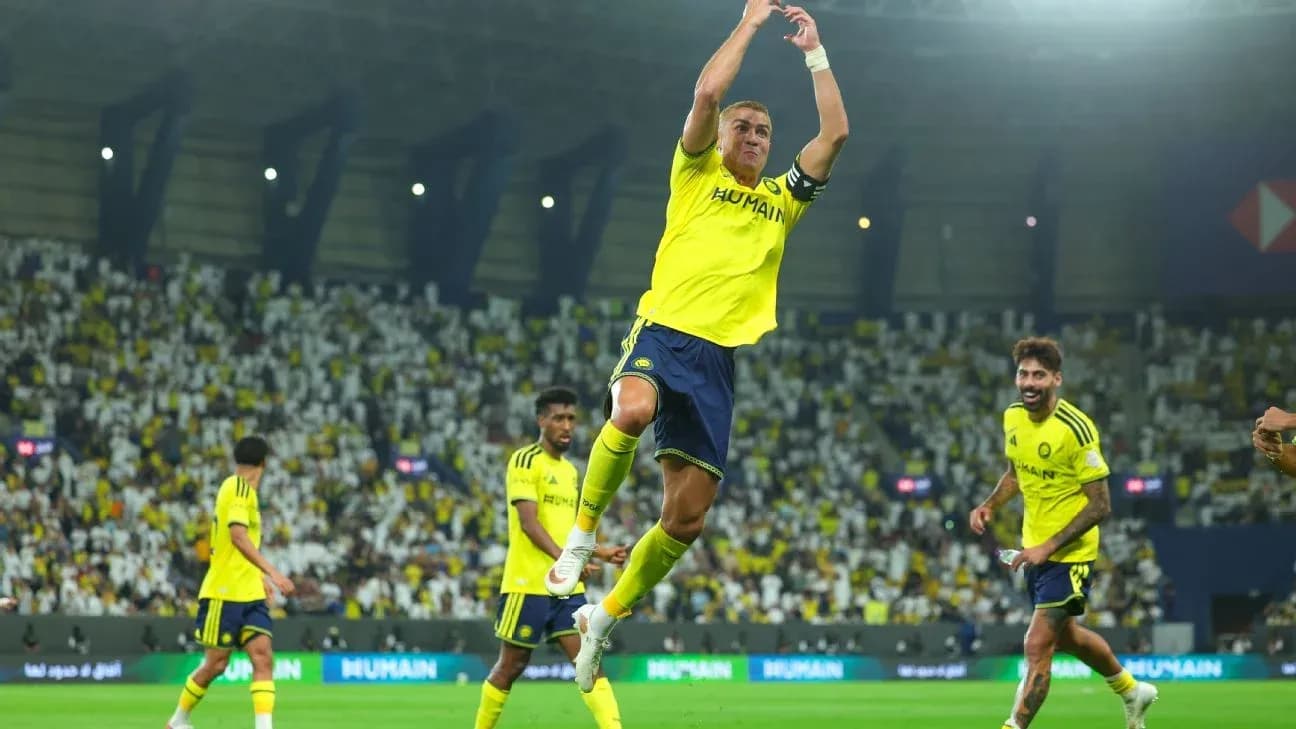 Player celebrating a goal with teammates on field