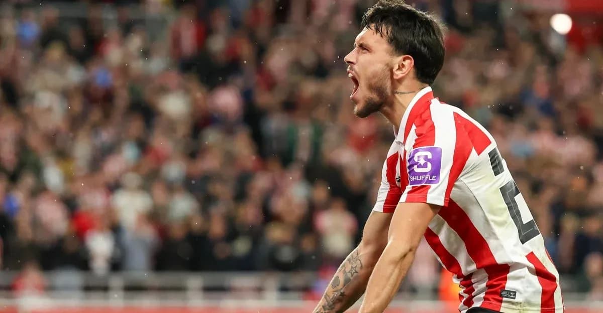 Player celebrating a goal with fans in background