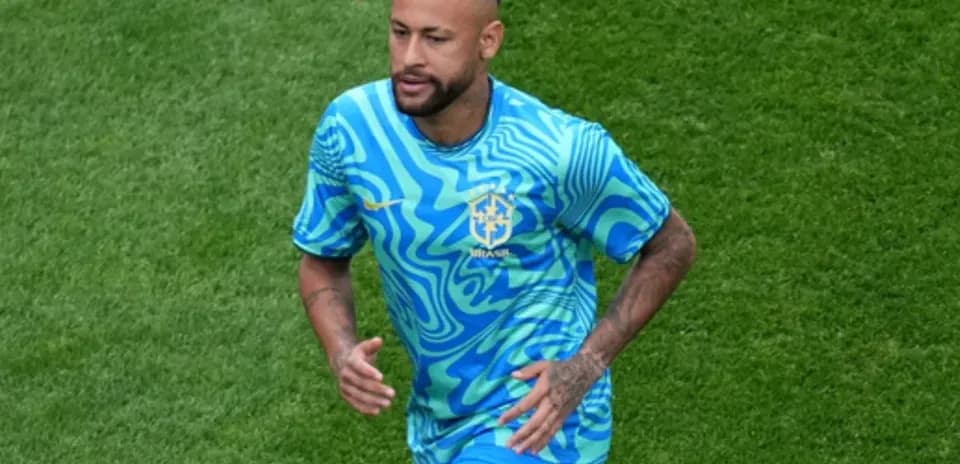Player running on field in Brazil training kit