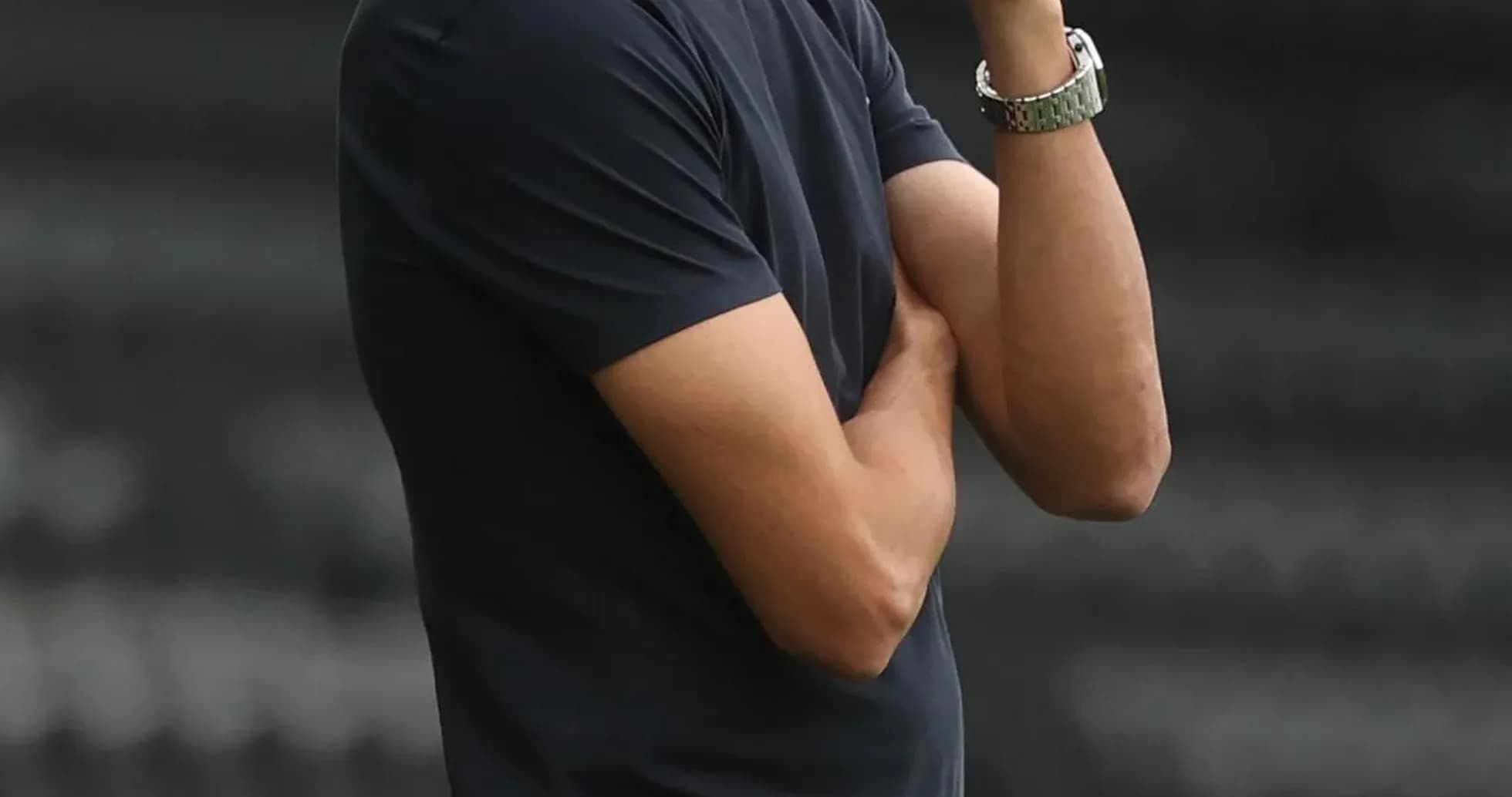 Coach observing the game with arms crossed