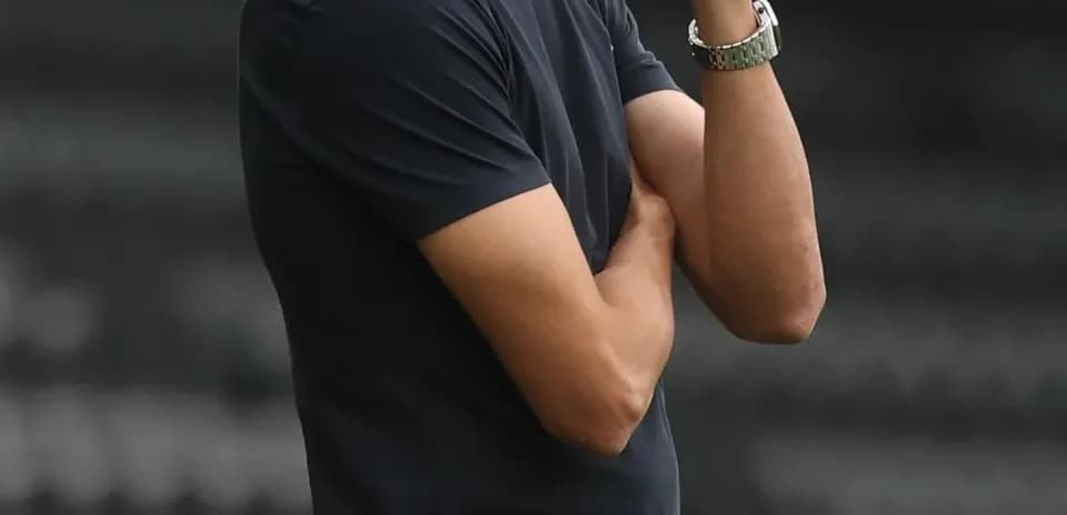 Coach observing the game with arms crossed