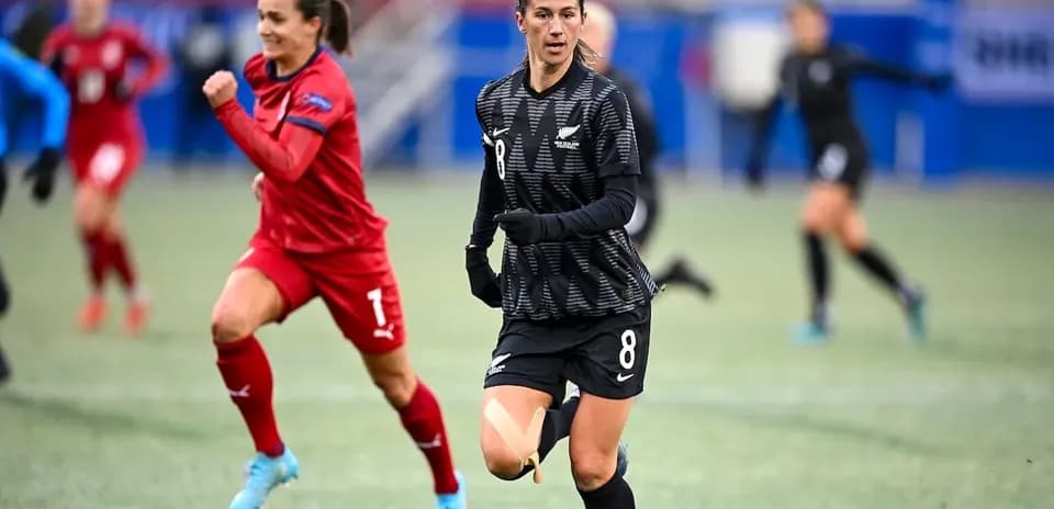 Player wearing black jersey running on soccer field