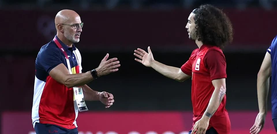 Coach and player exchanging greetings on the field
