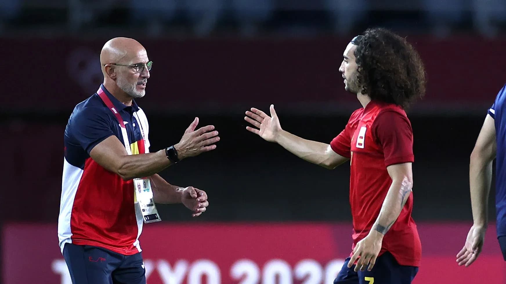 Coach and player exchanging greetings on the field