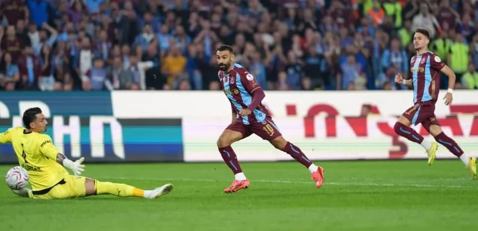 Player attempting to score against goalkeeper in match
