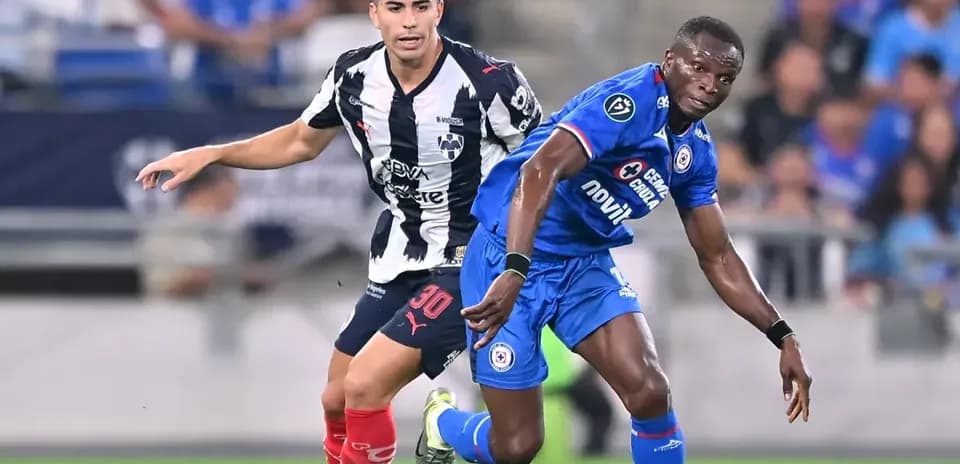 Monterrey player defending against Cruz Azul forward