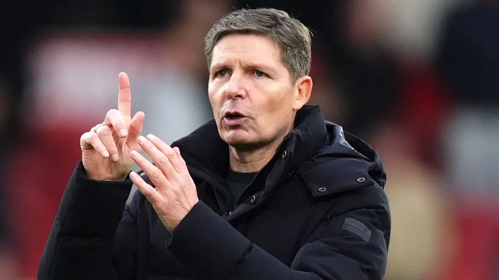 Coach gesturing during a match on the sidelines