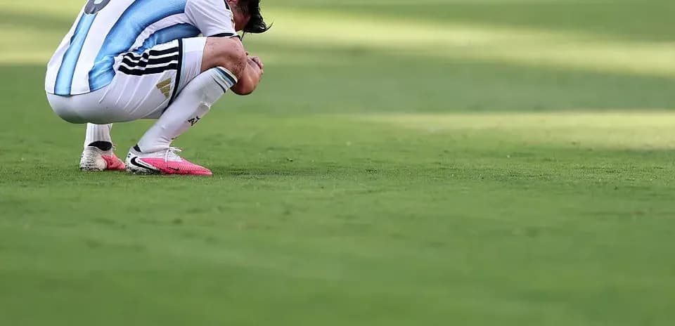 Player kneeling on the field after a match