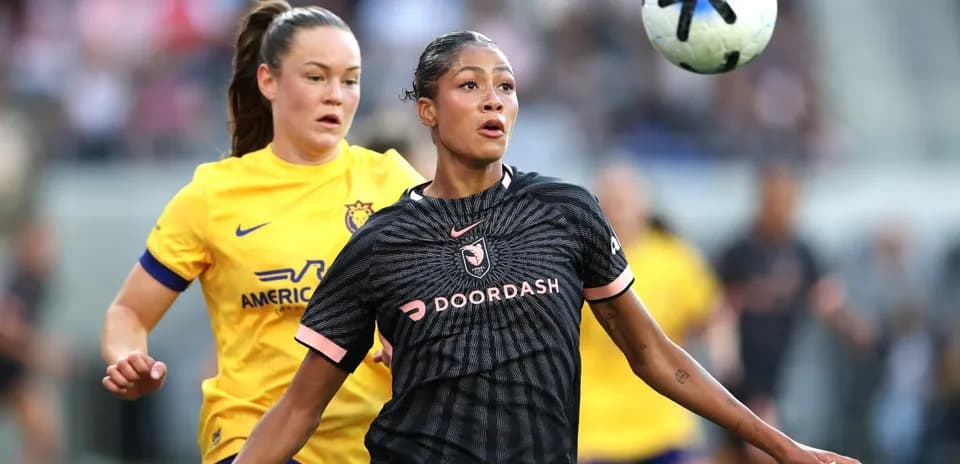 Angel City player challenging San Diego Wave opponent
